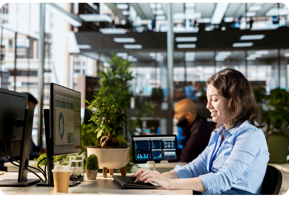 Woman smiling computer office looking at monitor with coffee